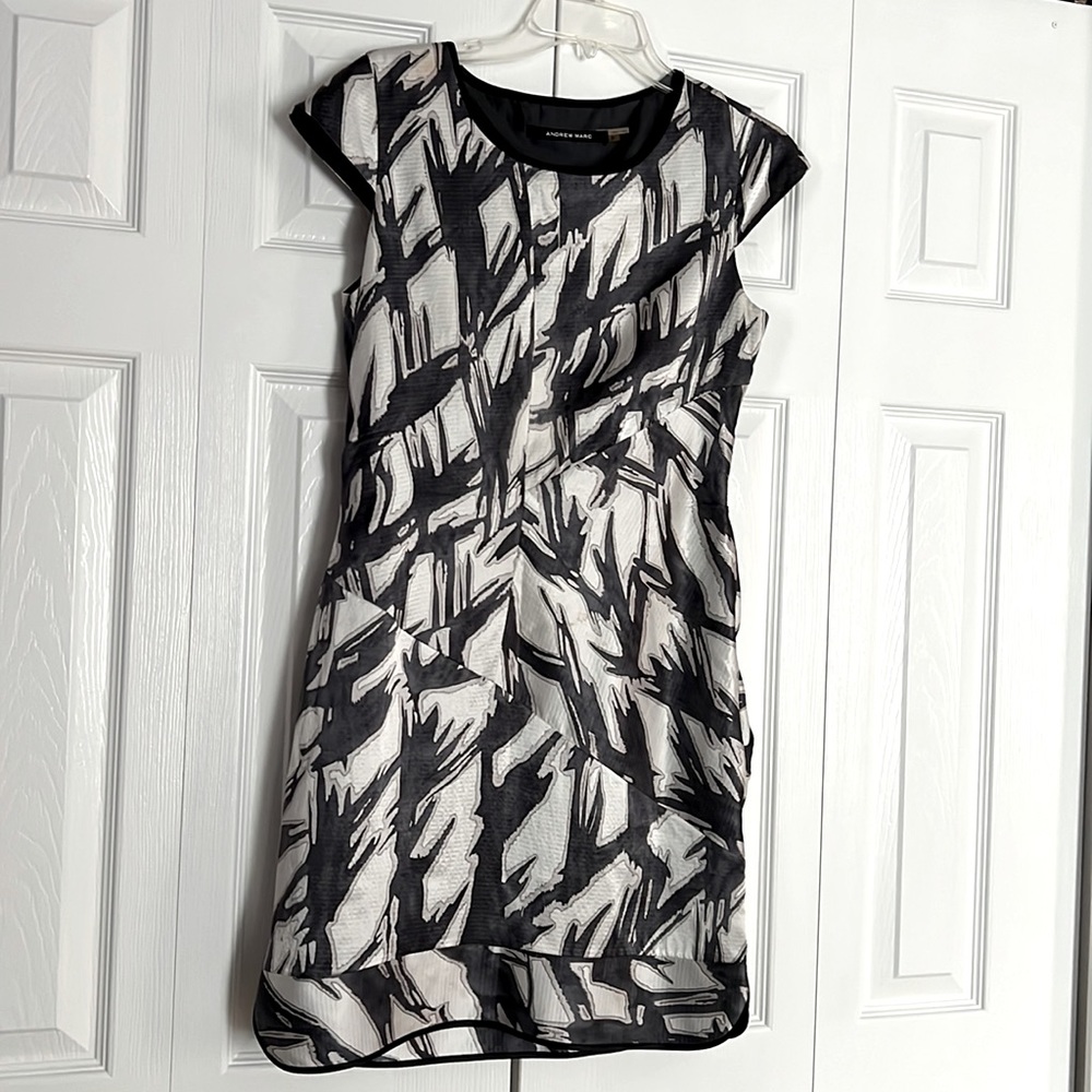 Asymmetrical design with gathering at the sides of dress makes it a show stopper